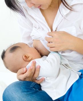 Asian mother breastfeeding her baby boy