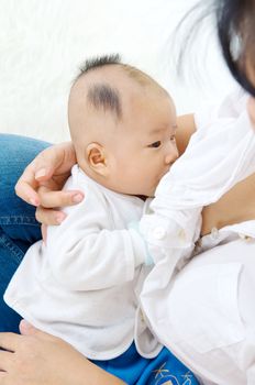 Asian mother breastfeeding her baby boy