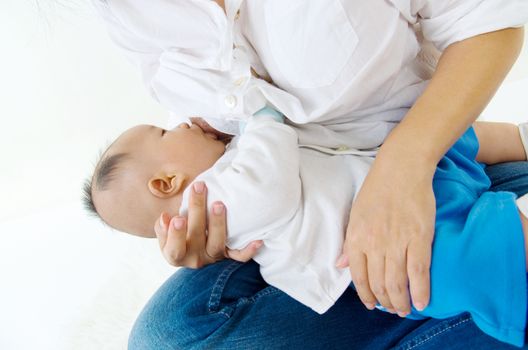 Asian mother breastfeeding her baby boy