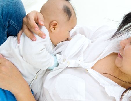 Asian mother breastfeeding her baby boy