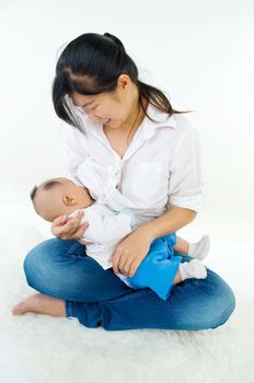 Asian mother breastfeeding her baby boy