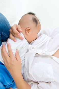 Asian mother breastfeeding her baby boy