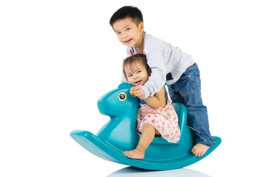 smiling asian kids  playing with Toy horse