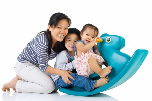 smiling asian family  playing with Toy horse