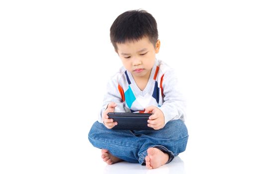 Asian boy playing game on digital tablet 