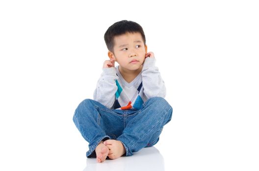 Cute boy feeling guilty with hand touch on his ear