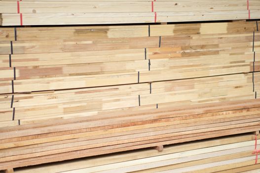 Stack of wood construction materials for building industry use as background.