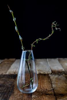 Dry flowers in a glass vase on a black background