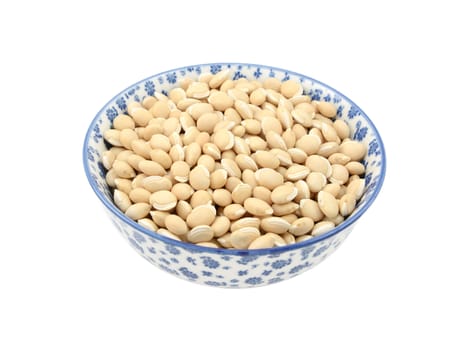 Neavy beans in a blue and white porcelain bowl with a floral design, isolated on a white background