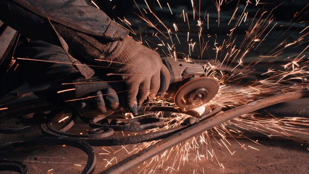 Close up of man's hands smoothing metal grate