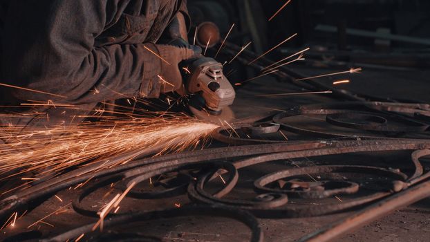 Close up of man's hands smoothing metal grate