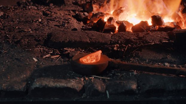 Close up of heated metal part near the fire