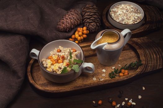 oatmeal with sea buckthorn butter and greens with pine nuts and sauce