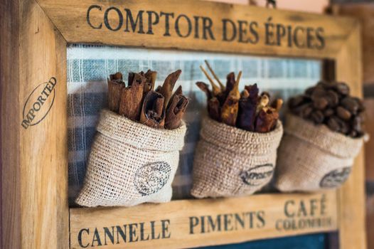 Close up view cinnamon sticks in little sack bag hanging on the wooden board in France