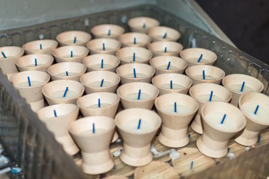 A group of Tea lights in a wooden box in a church