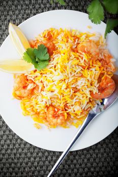 Indian Biryani with Shrimp and lemon on a table