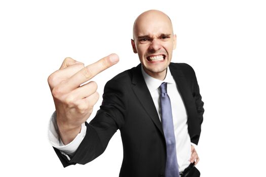 Angry young businessman shows middle finger. Studio shot isolated on white background. 