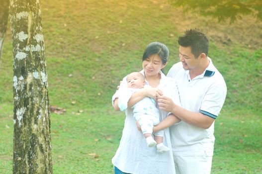 happy asian young family spending time outdoor on a summer day