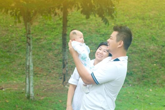 happy asian young family spending time outdoor on a summer day