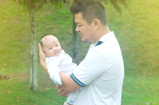 happy asian father and son spending time outdoor on a summer day