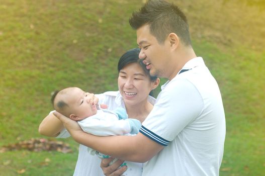happy asian young family spending time outdoor on a summer day