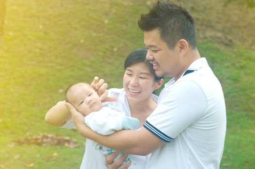 happy asian young family spending time outdoor on a summer day
