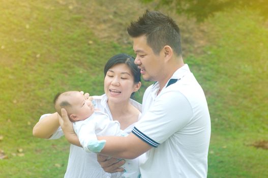 happy asian young family spending time outdoor on a summer day