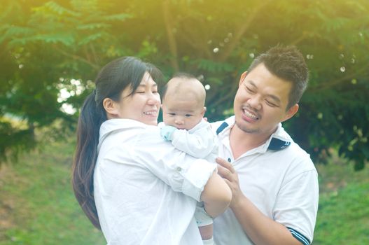 happy asian young family spending time outdoor on a summer day