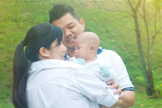 outdoor portrait of happy asian family
