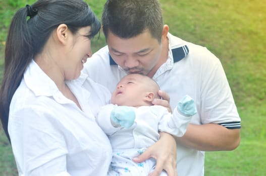 outdoor portrait of happy asian family