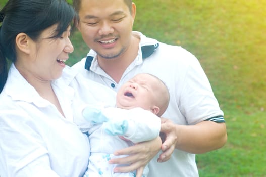 outdoor portrait of happy asian family