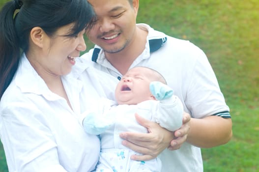 outdoor portrait of happy asian family