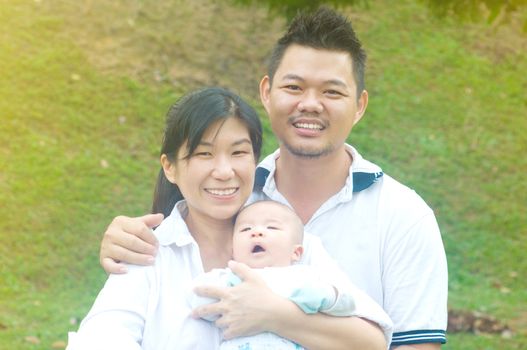 outdoor portrait of happy asian family
