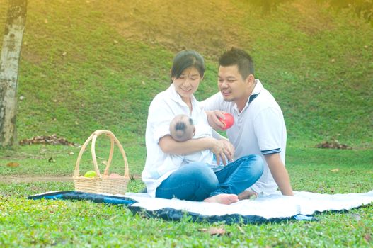 happy asian young family spending time outdoor on a summer day