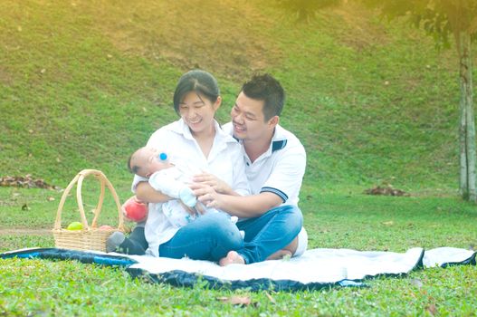 happy asian young family spending time outdoor on a summer day