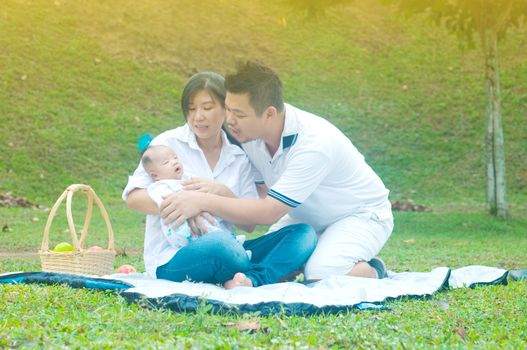 happy asian young family spending time outdoor on a summer day