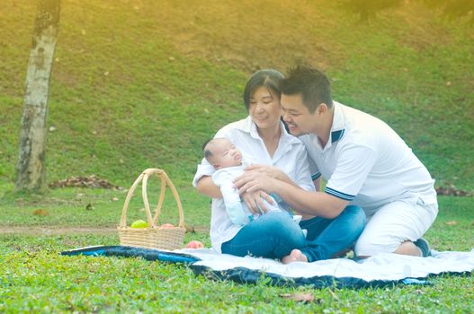 happy asian young family spending time outdoor on a summer day