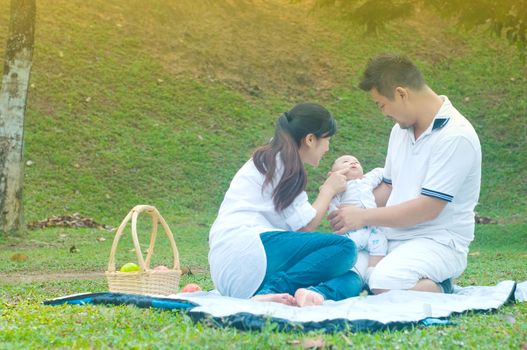 happy asian young family spending time outdoor on a summer day