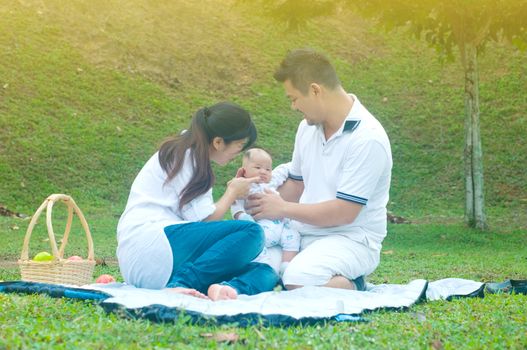 happy asian young family spending time outdoor on a summer day