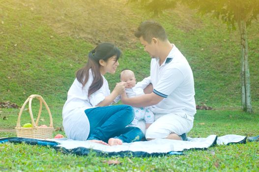 happy asian young family spending time outdoor on a summer day