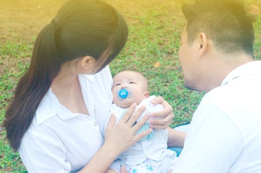 happy asian young family spending time outdoor on a summer day