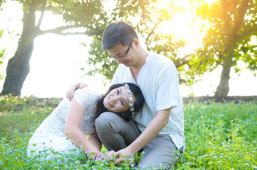 The asian couple embracing in the park