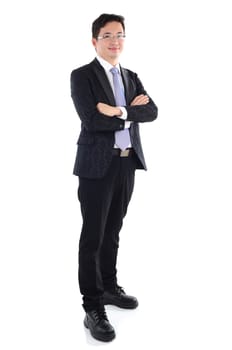 Confident Southeast Asian businessman crossed arms over white background