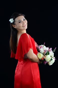 Beautiful asian woman dressed as a bride on white background