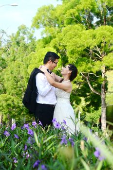 The asian couple embracing in the park