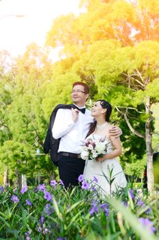 The asian couple embracing in the park