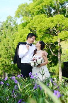 The asian couple embracing in the park