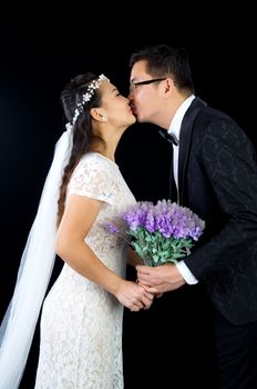 Attractive Bride and Groom at Wedding over black background