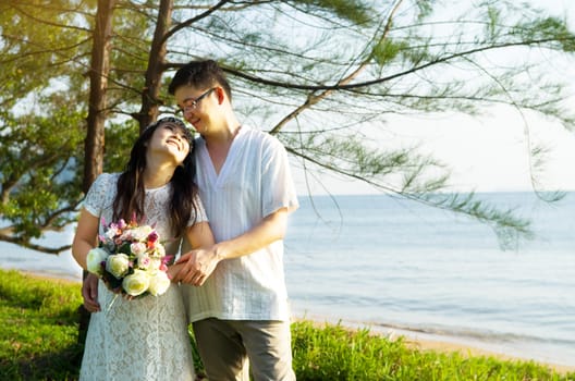 The asian couple embracing in the park