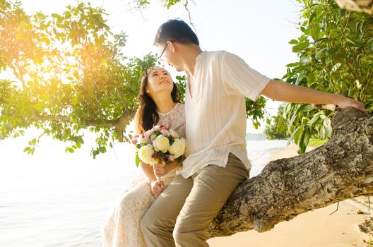 Outdoor Bride and groom on the beach in the evening.